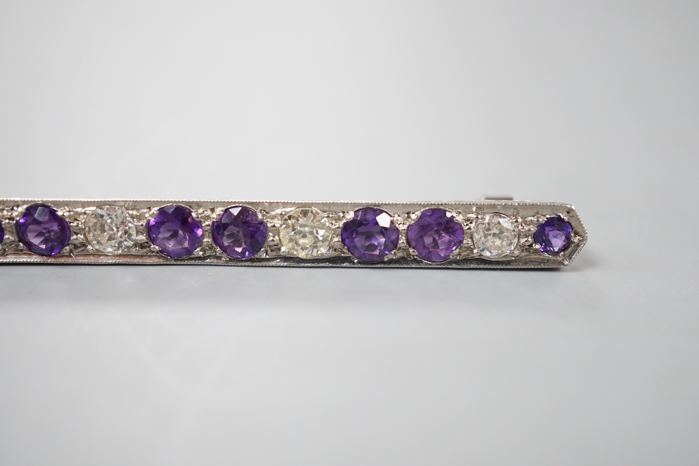 A mid 20th century white metal, amethyst and diamond set bar brooch, 57mm, gross weight 4.5 grams.